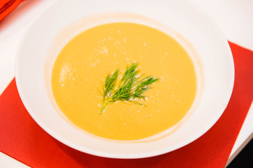 cream soup made of pumpkin in a plate