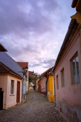 Fototapeta na wymiar Street in Sighisoara with colorful houses at dusk.