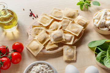 Top view healthy simple summer homemade food cooking raw vegetarian Italian pasta square ravioli with ingredients light flat lay