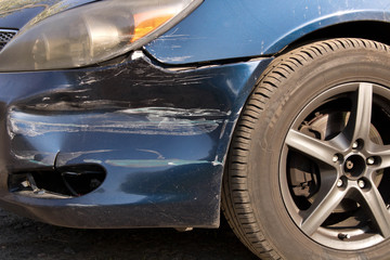 Obraz na płótnie Canvas Damaged car. Broken front bumper. The concept of road safety. Close up.