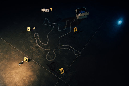 chalk outline, smartphone, dollar banknote, shoe, investigation kit and evidence markers at crime scene