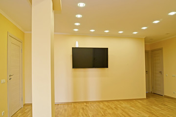 The hall with the TV on a wall