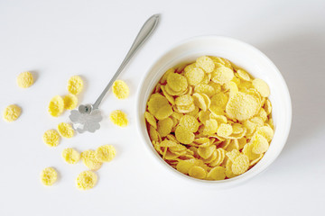 Healthy breakfast with cornflakes and milk over white background