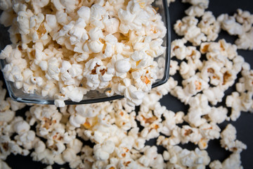 popcorn in a glass bowl on a black background
