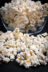 popcorn in a glass bowl on a black background
