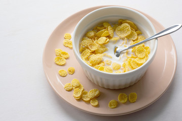 Healthy breakfast with cornflakes and milk over white background