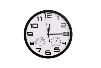 simple classic black and white round wall clock isolated on white. Clock with arabic numerals on wall shows 12:15 , 00:15