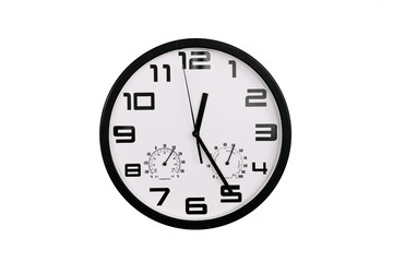 simple classic black and white round wall clock isolated on white. Clock with arabic numerals on wall shows 12:25 , 00:25