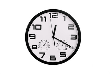 simple classic black and white round wall clock isolated on white. Clock with arabic numerals on wall shows 12:20 , 00:20