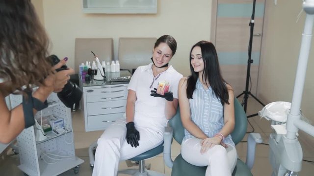 Photographer takes pictures of dentist and patient in dental clinic, slow motion