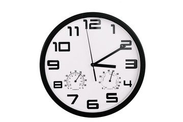 simple classic black and white round wall clock isolated on white. Clock with arabic numerals on wall shows 15:10 , 3:10