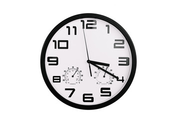 simple classic black and white round wall clock isolated on white. Clock with arabic numerals on wall shows 15:20 , 3:20