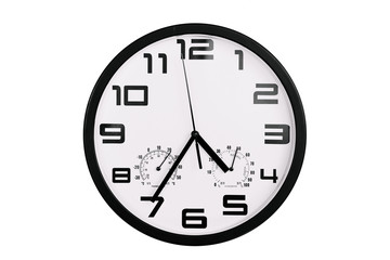 simple classic black and white round wall clock isolated on white. Clock with arabic numerals on wall shows 16:35 , 4:35