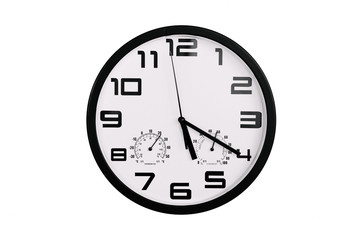 simple classic black and white round wall clock isolated on white. Clock with arabic numerals on wall shows 17:20 , 5:20