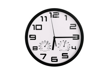 simple classic black and white round wall clock isolated on white. Clock with arabic numerals on wall shows 18:15 , 6:15