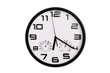 simple classic black and white round wall clock isolated on white. Clock with arabic numerals on wall shows 18:20 , 6:20