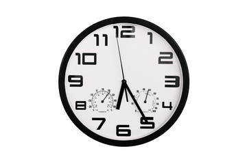 simple classic black and white round wall clock isolated on white. Clock with arabic numerals on wall shows 18:25 , 6:25