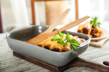 The process of cooking pasta cannelloni close up and copy space. Italian pasta with minced meat, sauce, garlic, tomatoes, parsley