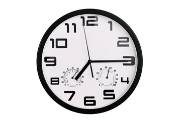 simple classic black and white round wall clock isolated on white. Clock with arabic numerals on wall shows 19:15 , 7:15