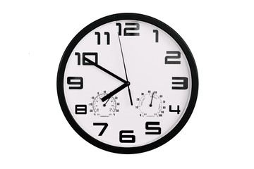 simple classic black and white round wall clock isolated on white. Clock with arabic numerals on wall shows 19:50 , 7:50