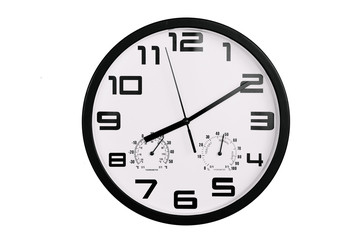 simple classic black and white round wall clock isolated on white. Clock with arabic numerals on wall shows 20:10 , 8:10