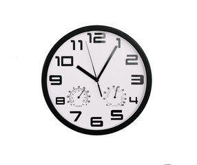 simple classic black and white round wall clock isolated on white. Clock with arabic numerals on wall shows 10:05 , 22:05