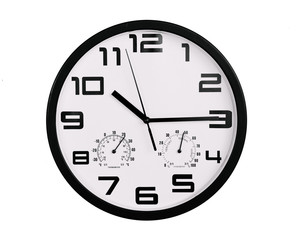 simple classic black and white round wall clock isolated on white. Clock with arabic numerals on wall shows 10:15 , 22:15