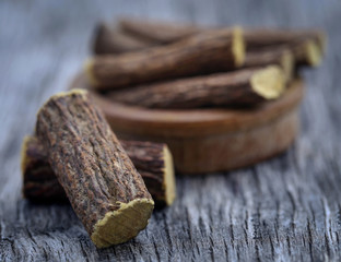 Liquorice stick in wooden bowl