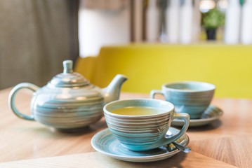 fruit tea in a beautiful blue tea set for two persons in a cozy cafe