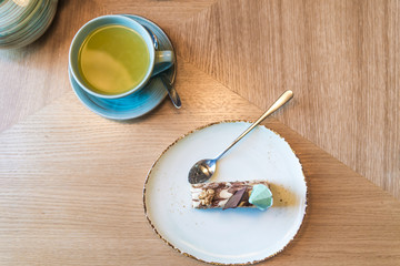 fruit tea with sweet cake, beautiful blue tea set on top view table