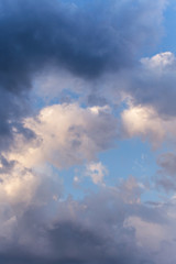 Fototapeta na wymiar Epic dramatic storm cumulus fluffy white clouds in sunlight against blue sky background, heaven