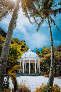 Abandoned Matinloc Shrine between two palm trees at the western coast of Matinloc Island at Palawan, Philippines