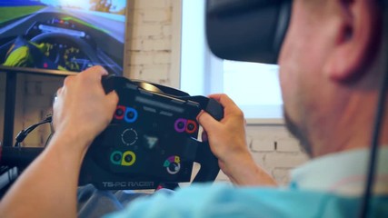 mature man takes part in car racing with high-tech simulator - Powered by Adobe