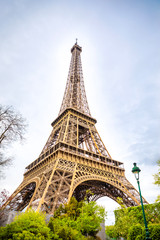 View from the bottom of The Eiffel Tower in Paris in cloudy day, France