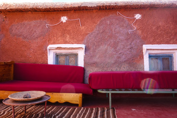 Two old red couches on a terrace in Tamellalt in Dades Gorges, Atlas Mountains, Morocco