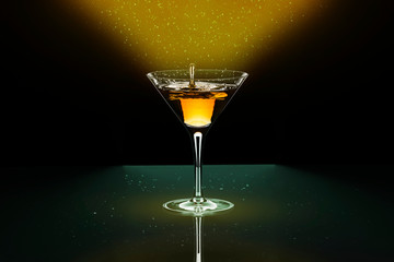 Cocktail yellow-red in baikal for martini with a beautiful splash of drops.