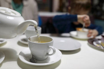 Person pouring green tea
