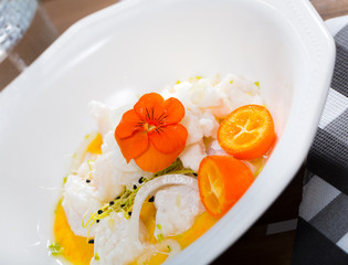 Ceviche from horse-mackerelon plate with cumquat, greens  and spicy avocado sauce