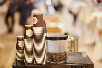Disposable cardboard cups for coffee. Coffee machine