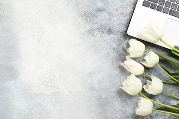Fresh flower composition, bouquet of bi color pink tulips with black and white laptop computer,...