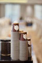 Disposable cardboard cups for coffee. Coffee machine