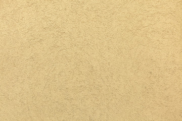 Yellow painted stucco wall. Background texture