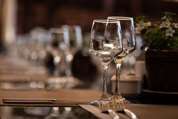 a pair of wine glasses at a banquet table