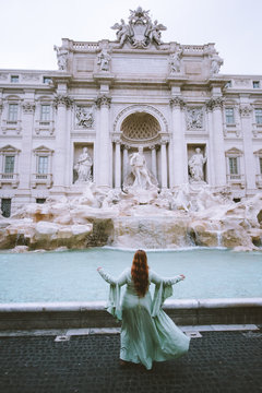 in gown by showy fountain
