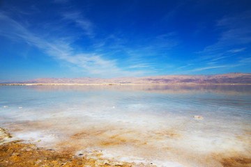 Beautiful view of salty Dead Sea shore with clear water. Ein Bokek, Israel.