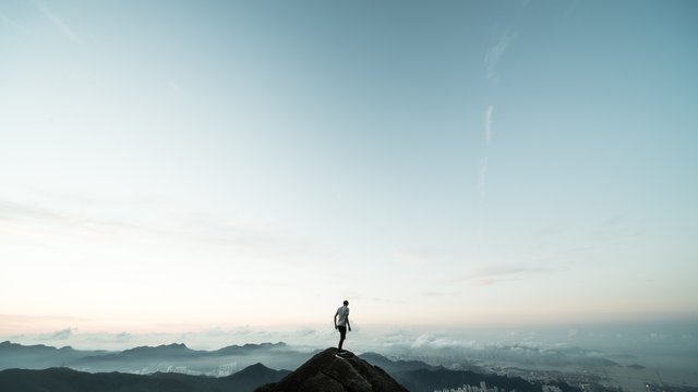 man standing on top of a mountain
