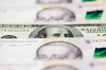 Dollars and hryvnia banknotes background. 500 hryvnia banknotes USA 100 dollars bills. Money background