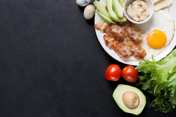 Fototapeta na wymiar Ketogenic diet: bacon, avocado, hummus, tomato, eggs. Healthy fats.