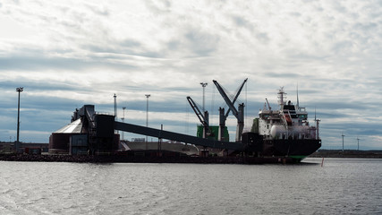 Ships in the cargo port during cargo operation. Ship working on gasoil.