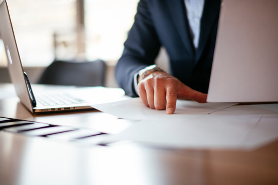 Close-up Of Businessman`s Hands Doing Paperwork In The Office